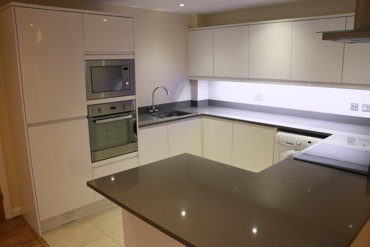 Modern fitted kitchen — Ladymere Place apartment refurbishment, Godalming