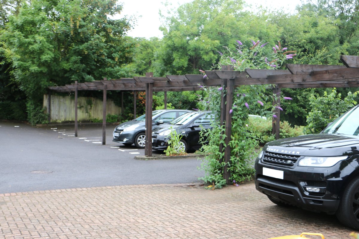 Pergola-shaded parking — Ladymere Place residential development, Godalming