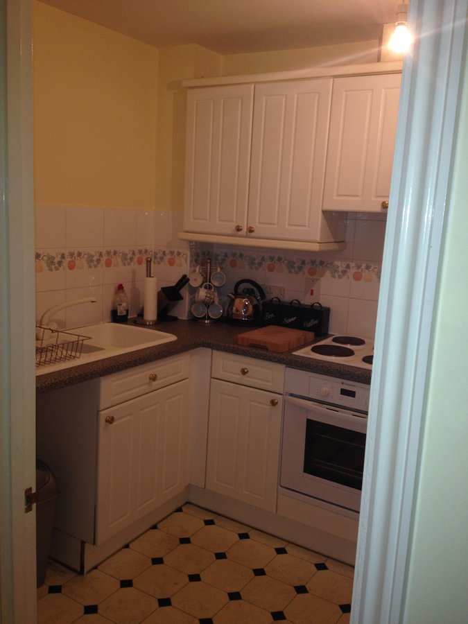 Before refurbishment — original dated kitchen, Ladymere Place apartment, Godalming