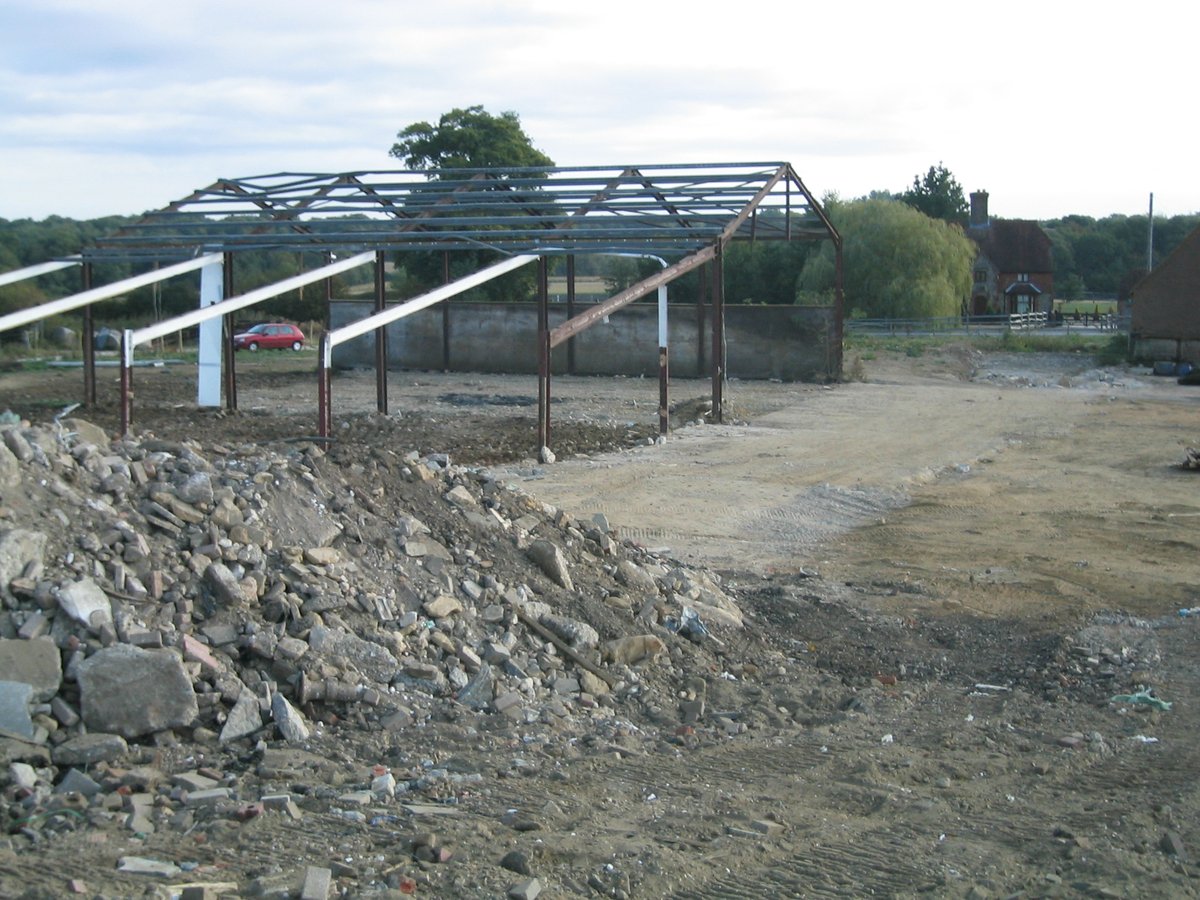 New steel frame structure during barn conversion works — West Sussex heritage land restoration