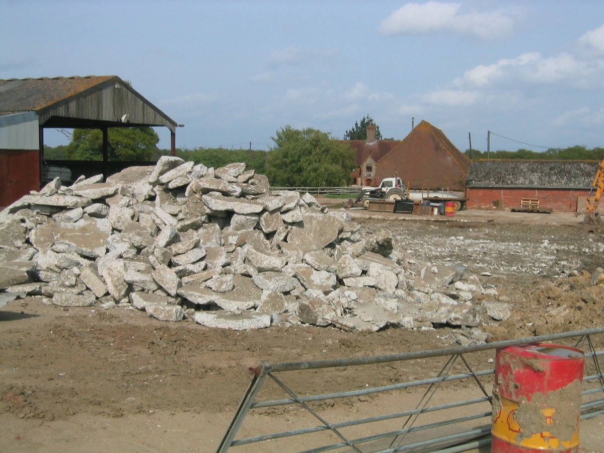 Demolition rubble pile on cleared barn site — West Sussex land restoration project