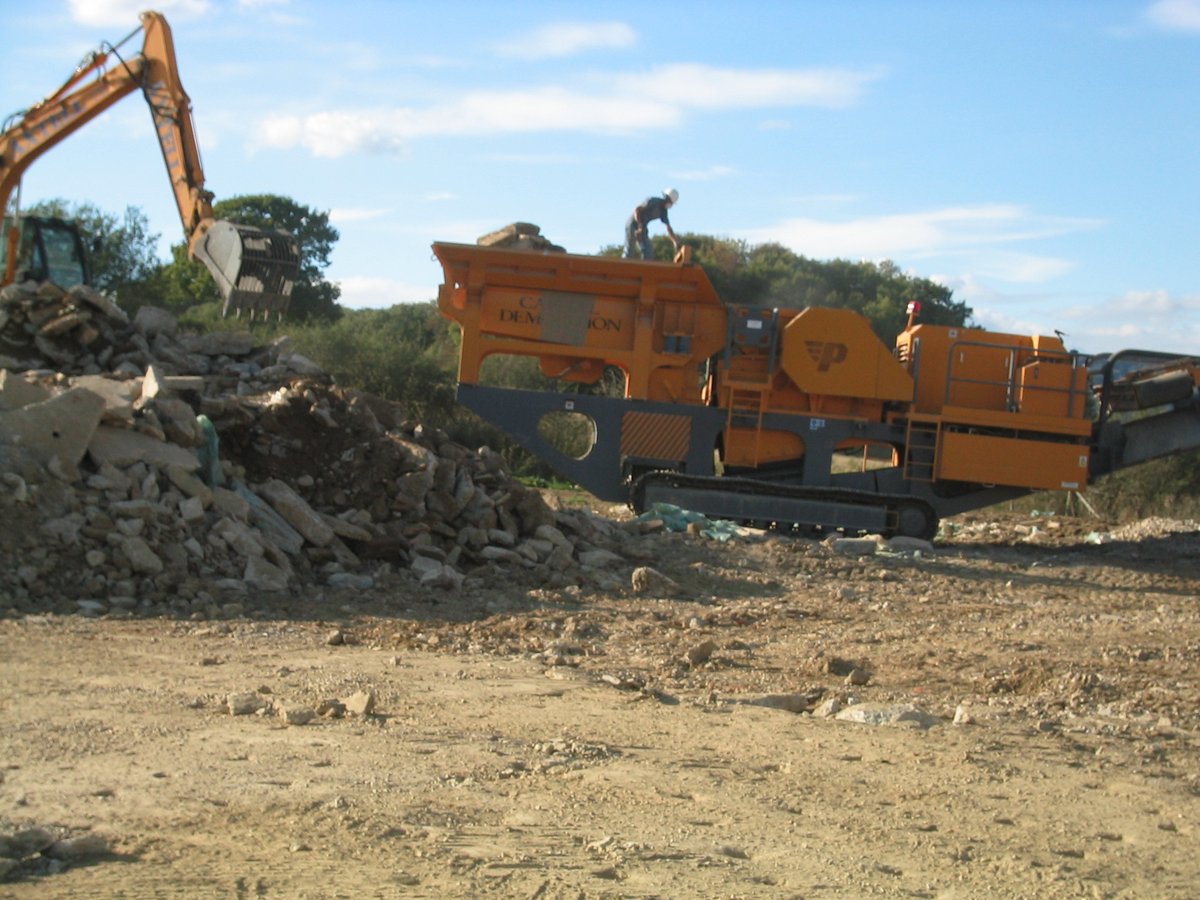 Axtell rubble crusher machine processing demolition material on-site — West Sussex barn restoration