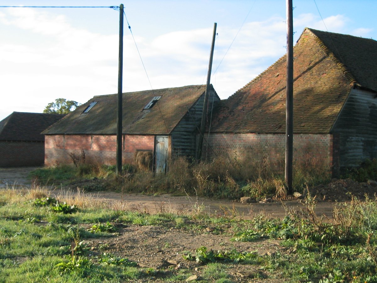 Original grey weatherboarded barn side elevation — West Sussex heritage site, before restoration