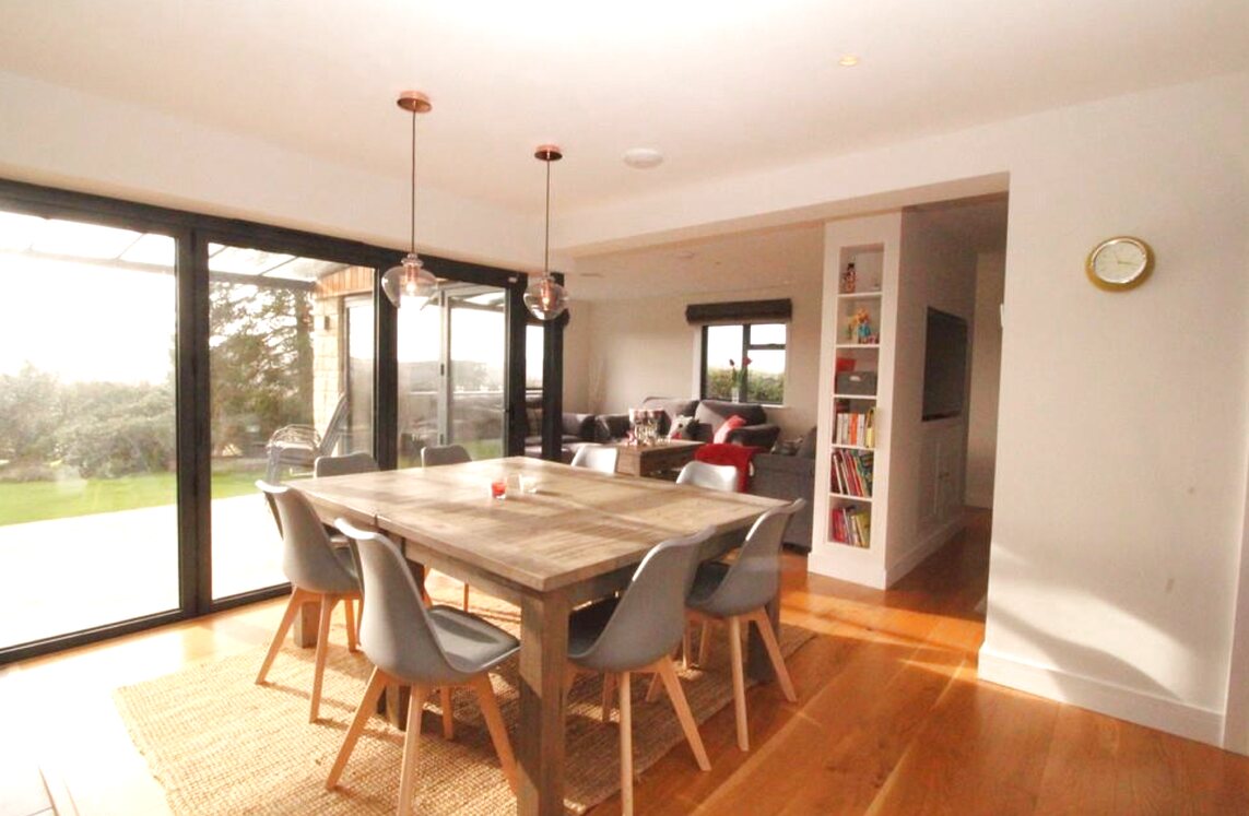 Open-plan dining with bifold doors and Tyne valley views — Northumberland contemporary home