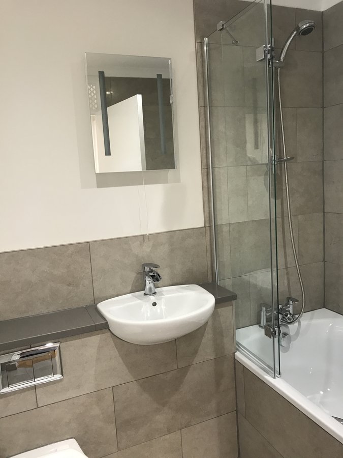 Walk-in shower bathroom — Weyview Court apartment, Guildford post-flood remediation