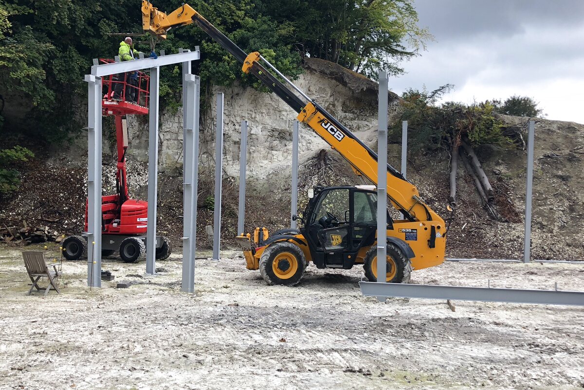 Telehandler erecting steel frame — Quarry Works industrial new-build, Surrey principal contractor