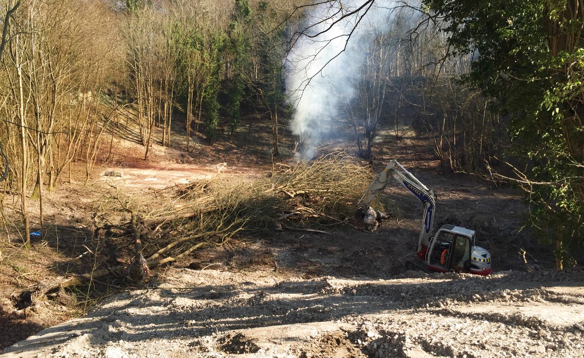 Initial site clearance with controlled burn — Quarry Works new-build site preparation, Surrey