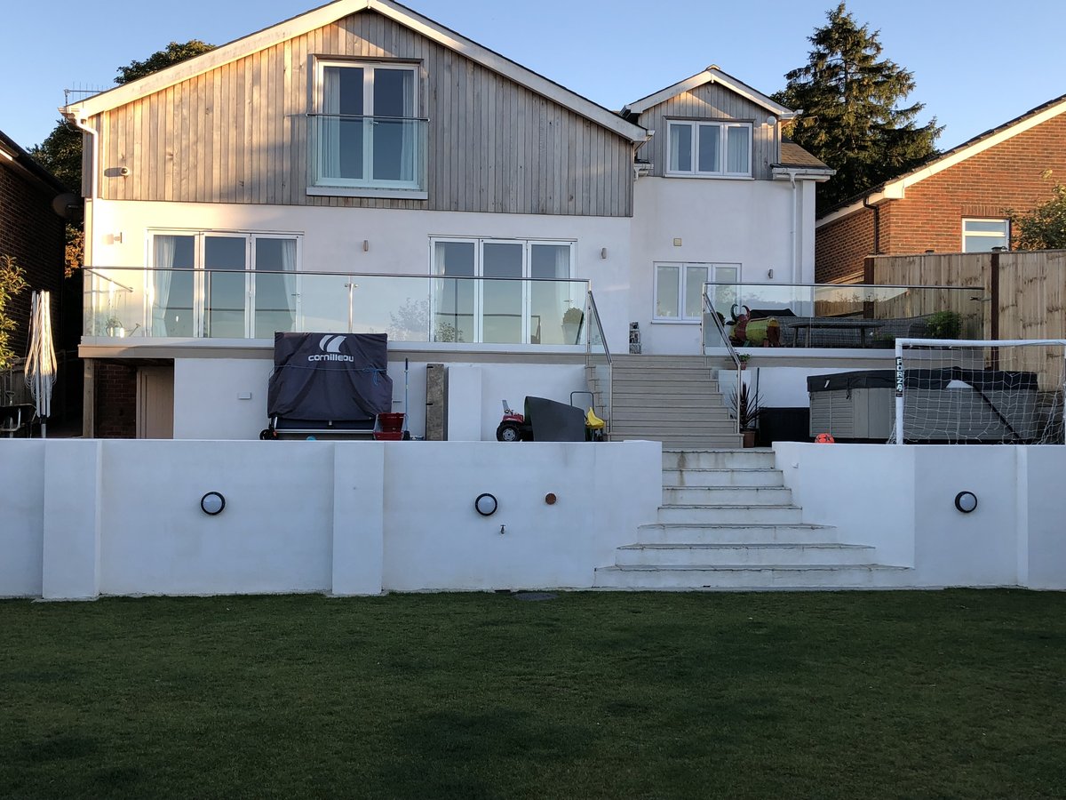 Completed contemporary cedar-clad rear with terrace — The Mount, Guildford whole-house transformation