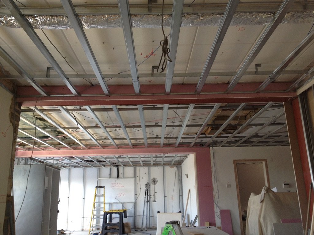 Mid-construction stripped-back interior with steel ceiling supports — The Mount, Guildford