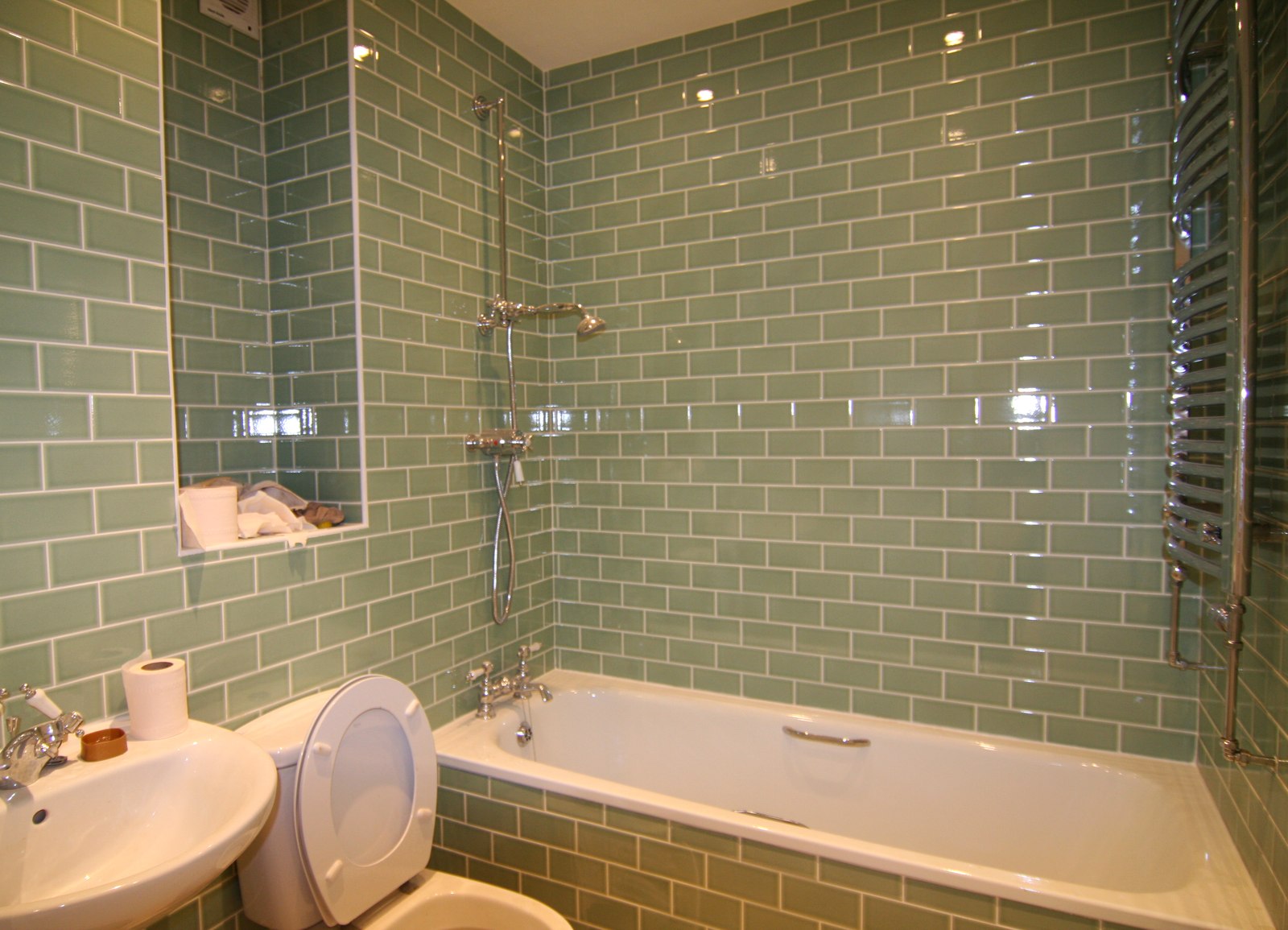 Sage green metro tile bathroom with chrome fittings — Victorian conversion apartment, Surrey