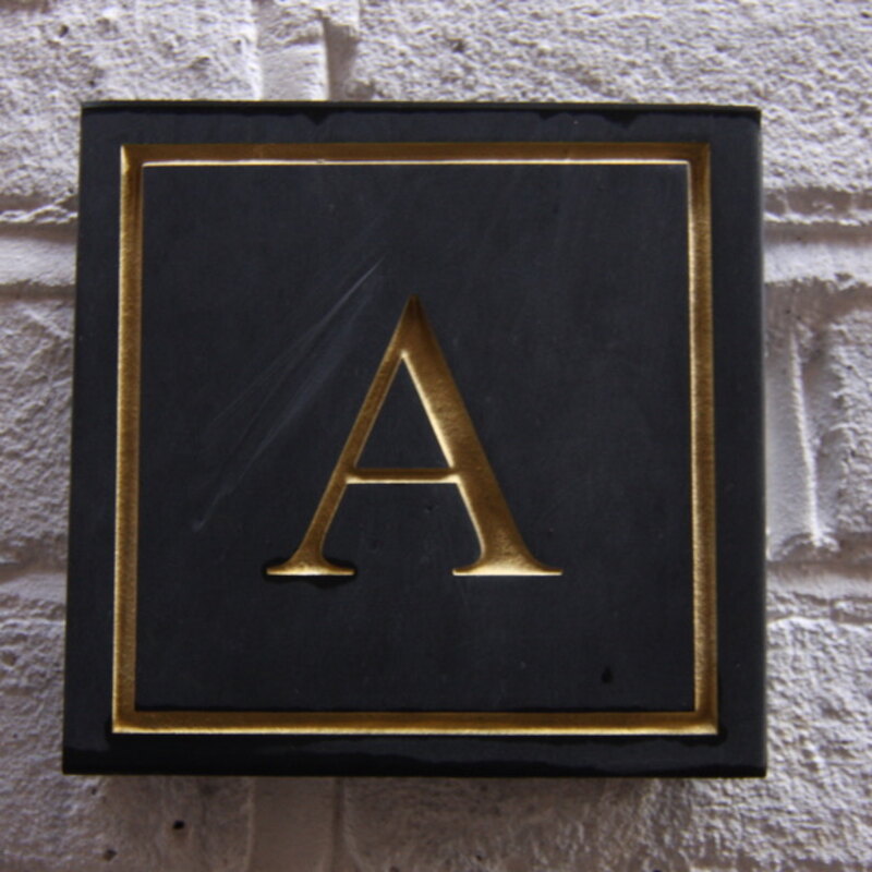 Brass address plaque on whitewashed brick — Victorian apartment conversion, Surrey